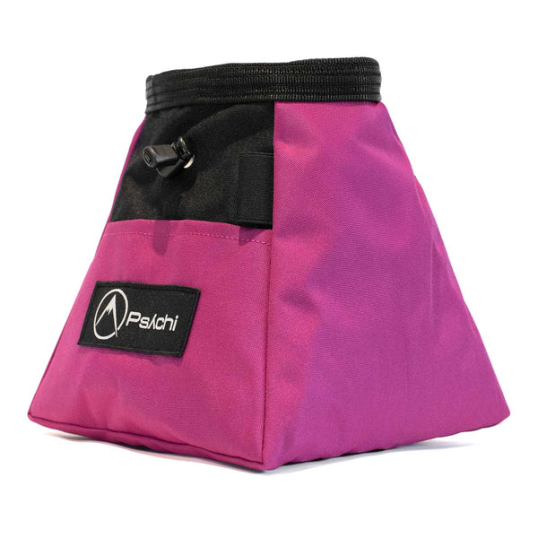 A magenta and black bouldering chalk bucket with drawstring closure and climbing accessory pockets