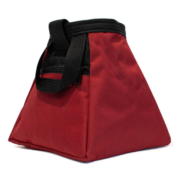 A red and black bouldering chalk bucket with drawstring closure and climbing accessory pockets