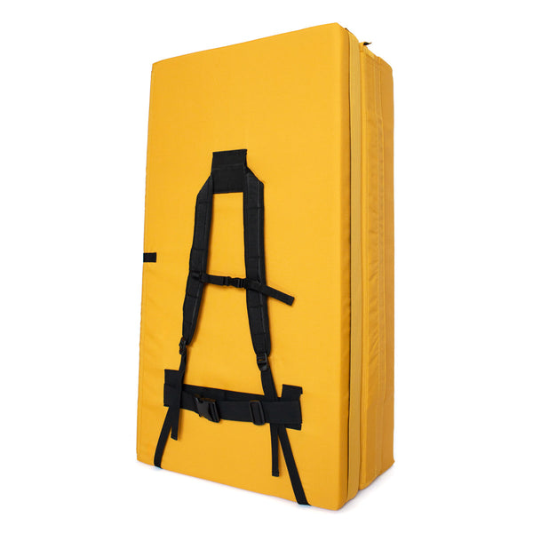 A yellow psychi bouldering crash pad dual layer triple fold 