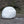 A psychi chalk ball sits on some gritstone in the Peak District