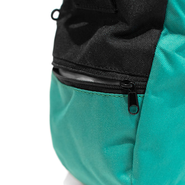 A turqoise rock climbing chalk bag with zip closure climbing accessory pocket