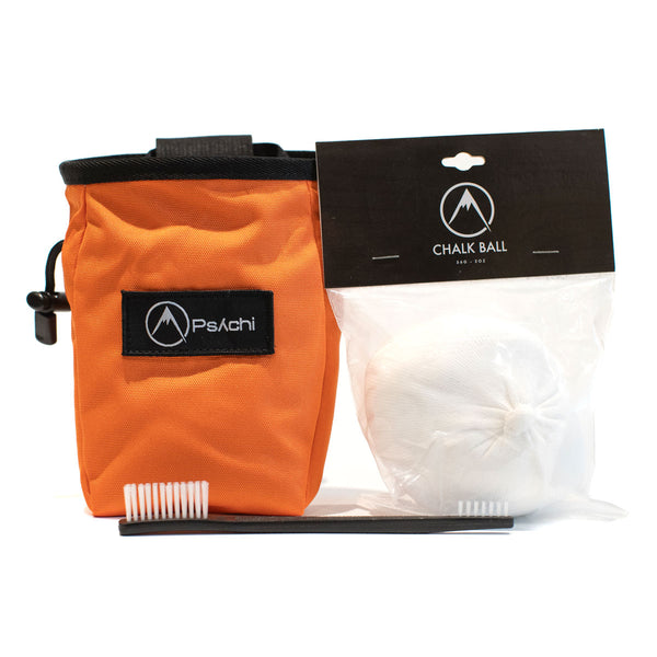 A light orange climbing chalk bag with a 56g chalk ball and plastic double ended brush