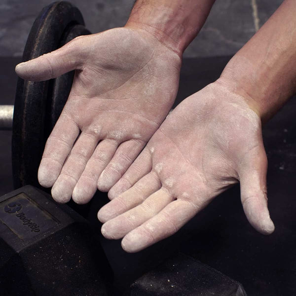 A climber's hands with a thin effective layer of climbing chalk